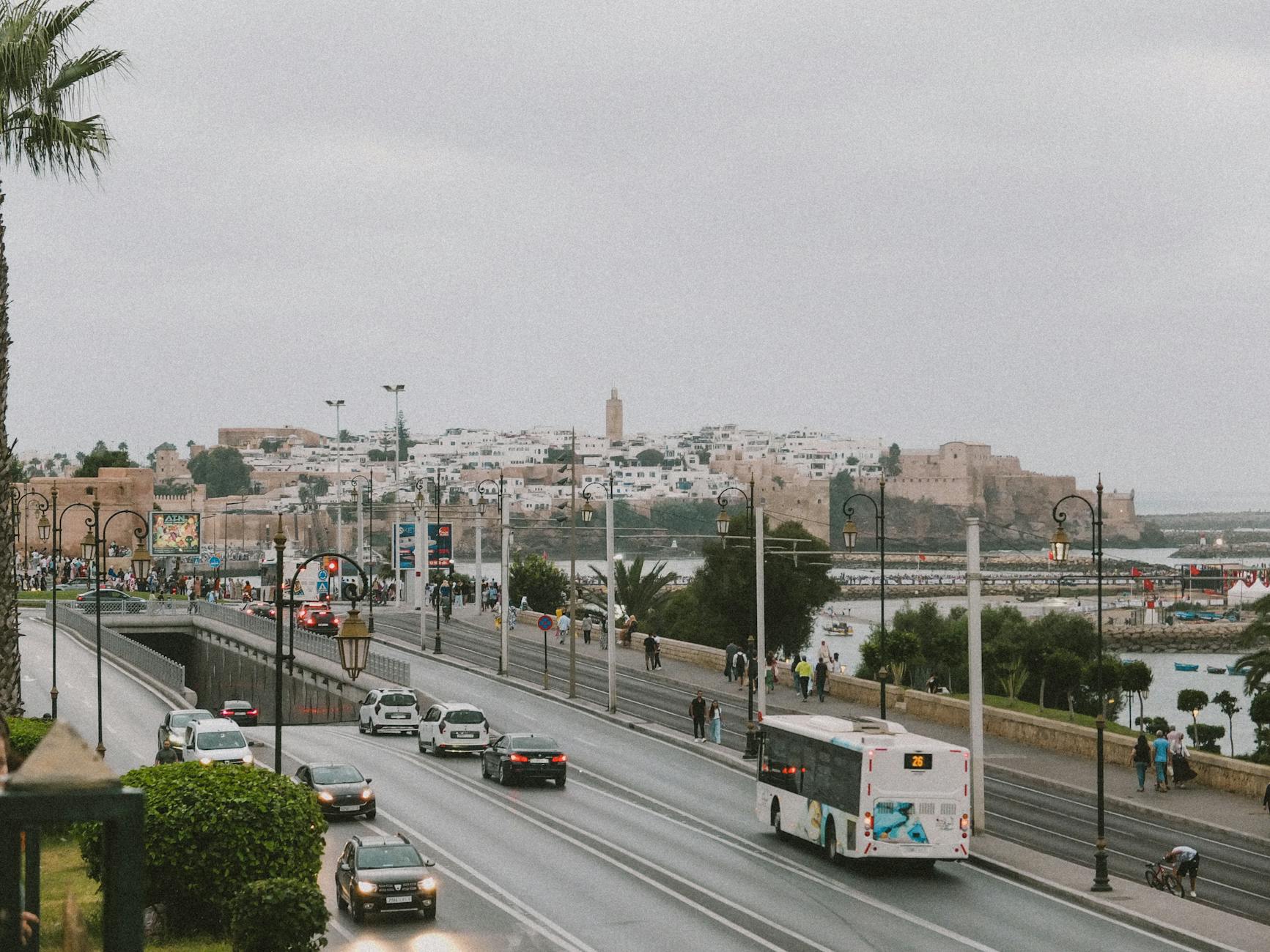 Scenic view of Rabat with traffic, bridge, and historic architecture on a cloudy day.