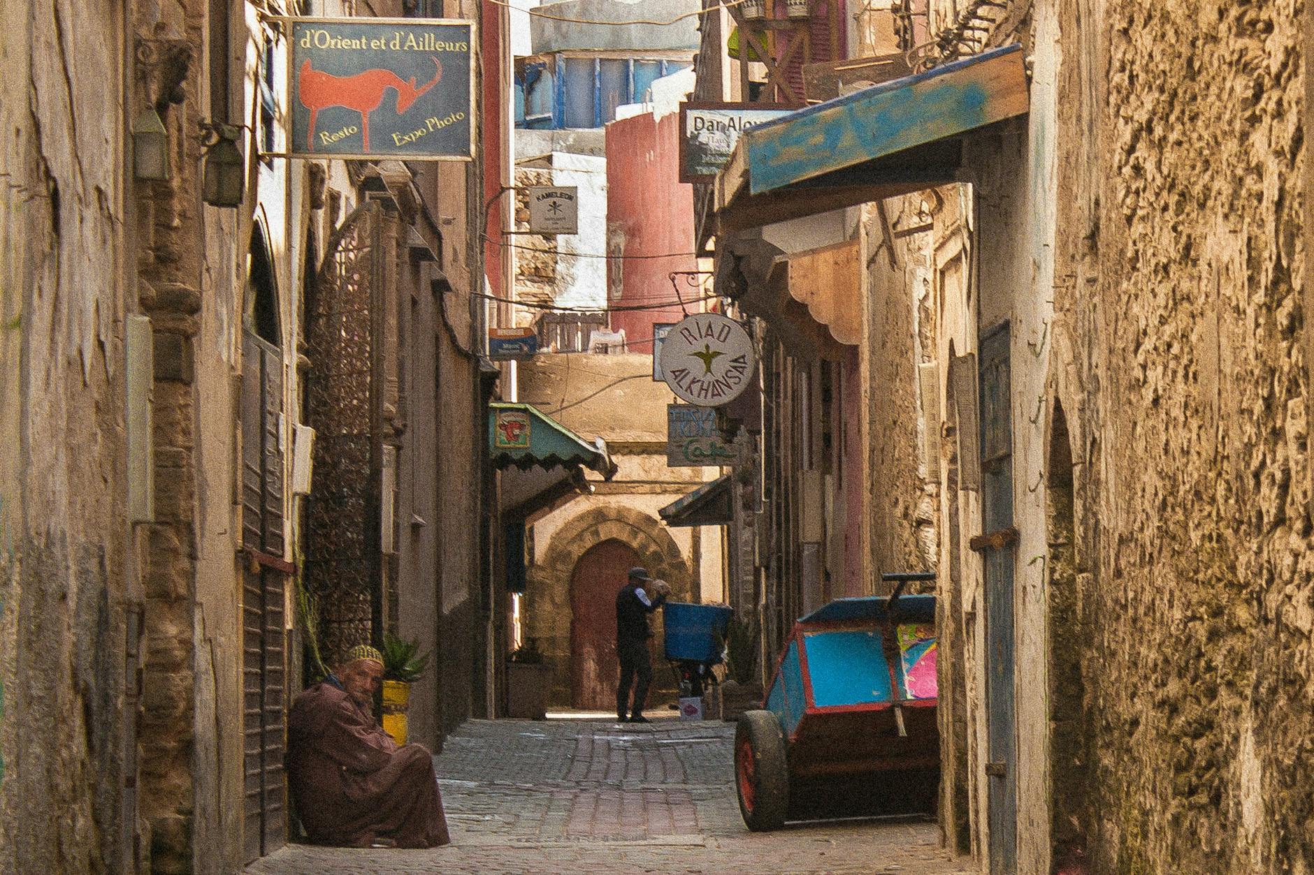 Explore the old city's charm in Essaouira with a picturesque narrow alleyway scene.