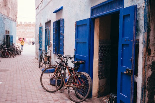 Discover the vibrant blue doors and bicycles in the narrow alleyways of Essaouira, Morocco.