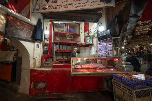 Explore a traditional butcher shop in the vibrant medina of Fez, Morocco, bustling with local activity.