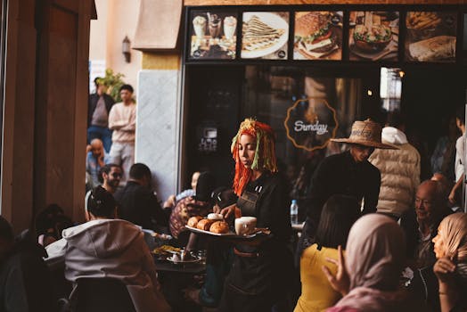 Vibrant cafe in Agadir with diverse crowd and lively atmosphere.