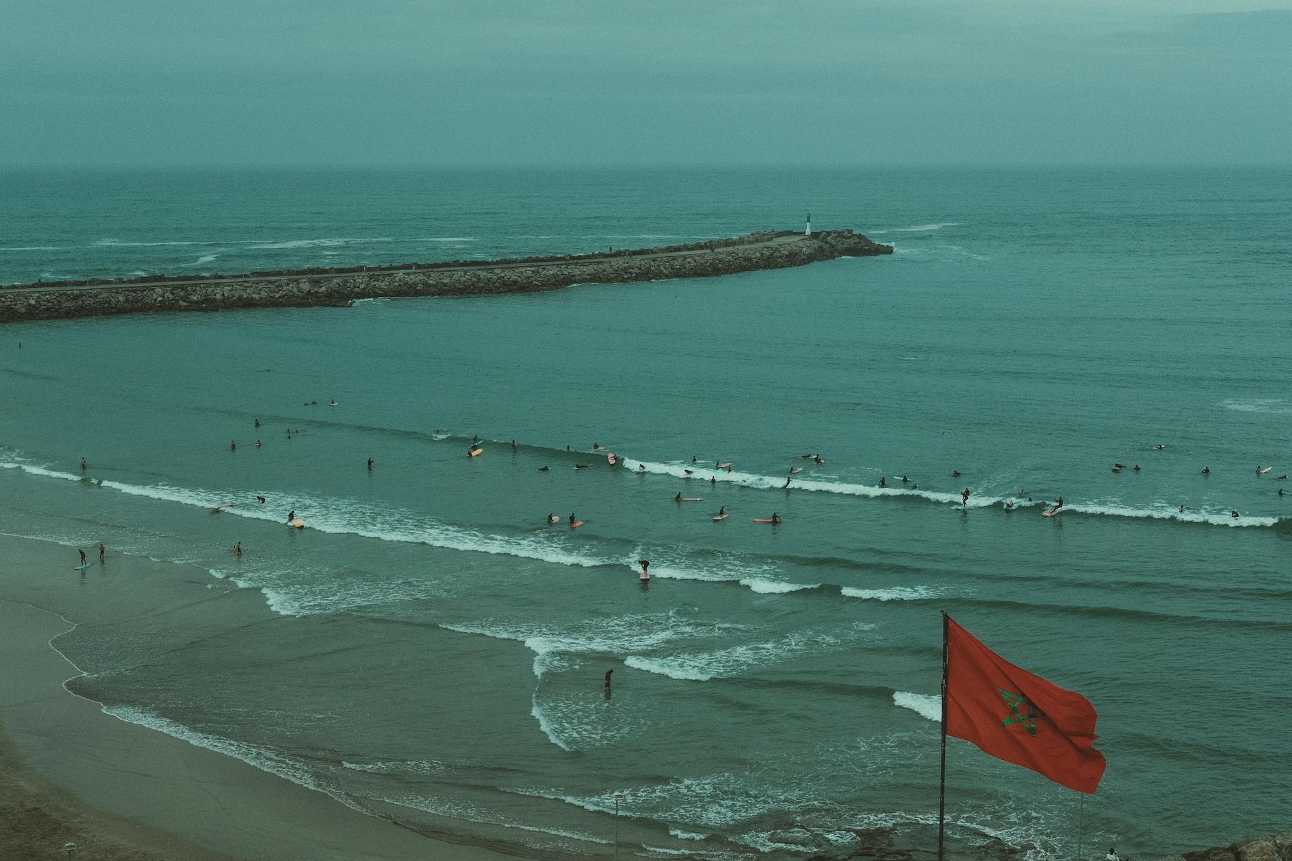Surfer riding waves on the Atlantic coast near Essaouira, Morocco